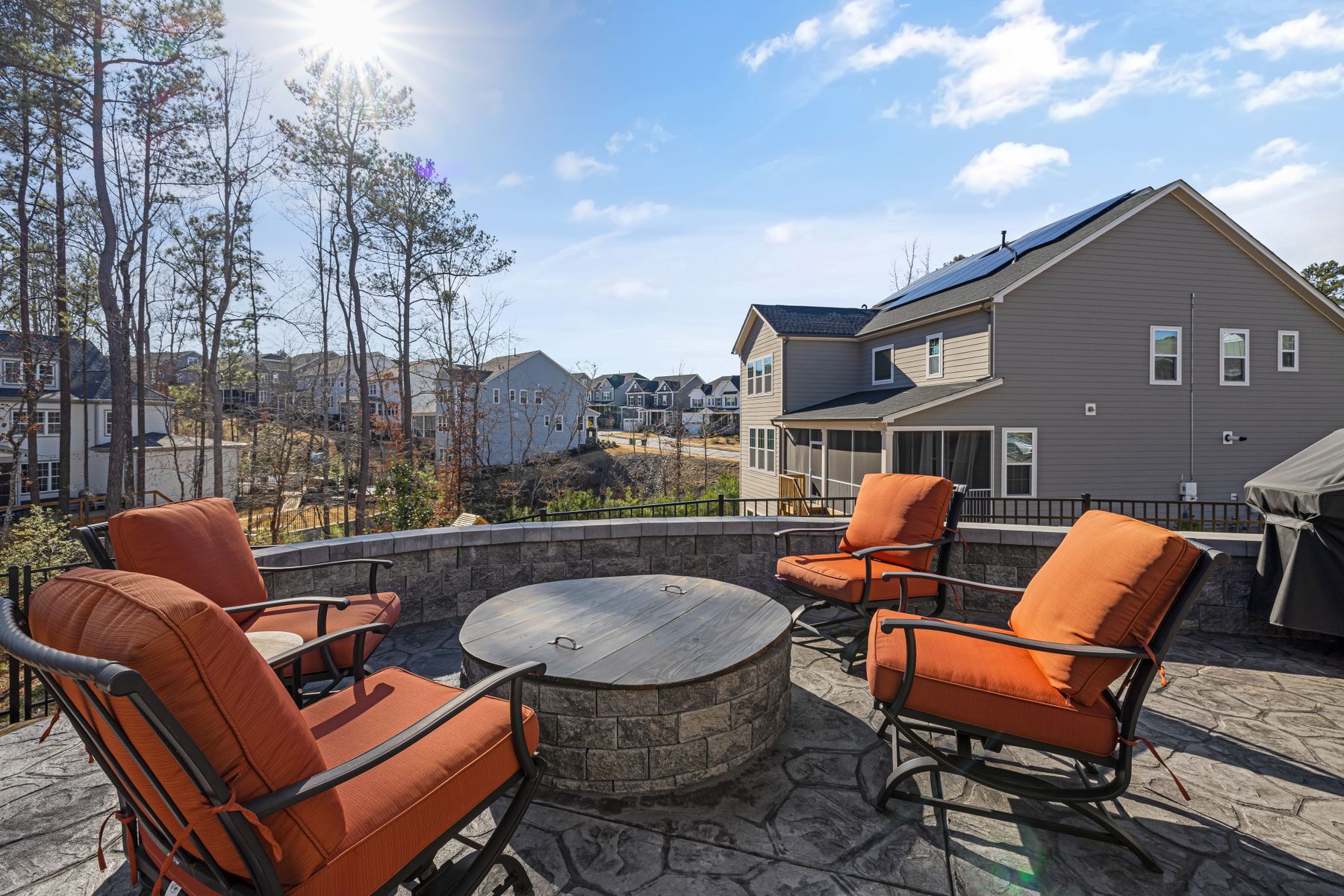 Decorative concrete patio with a fire pit and patio furniture